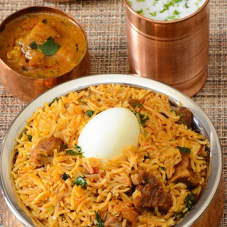 Mutton Biryani (served with raita, egg and eggplant curry)