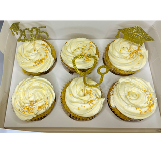 All white cupcakes with gold toppers and gold sprinkles