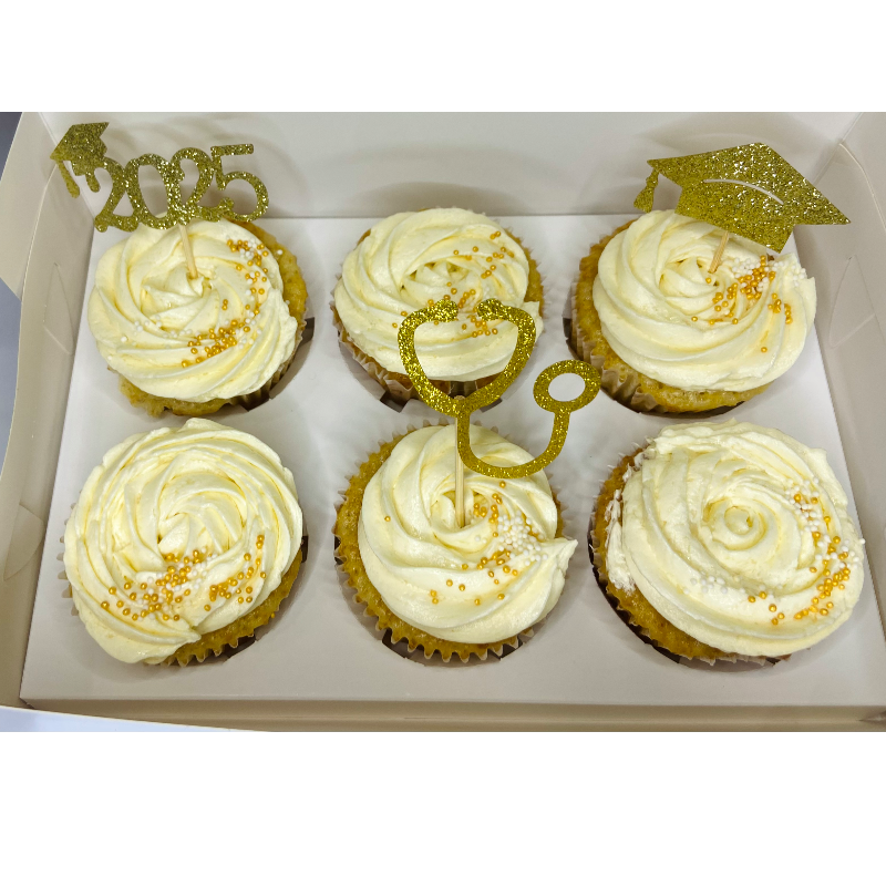 All white cupcakes with gold toppers and gold sprinkles