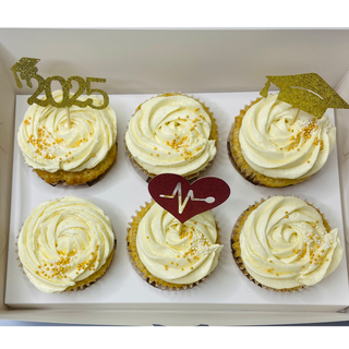 White frosting with gold and red toppers