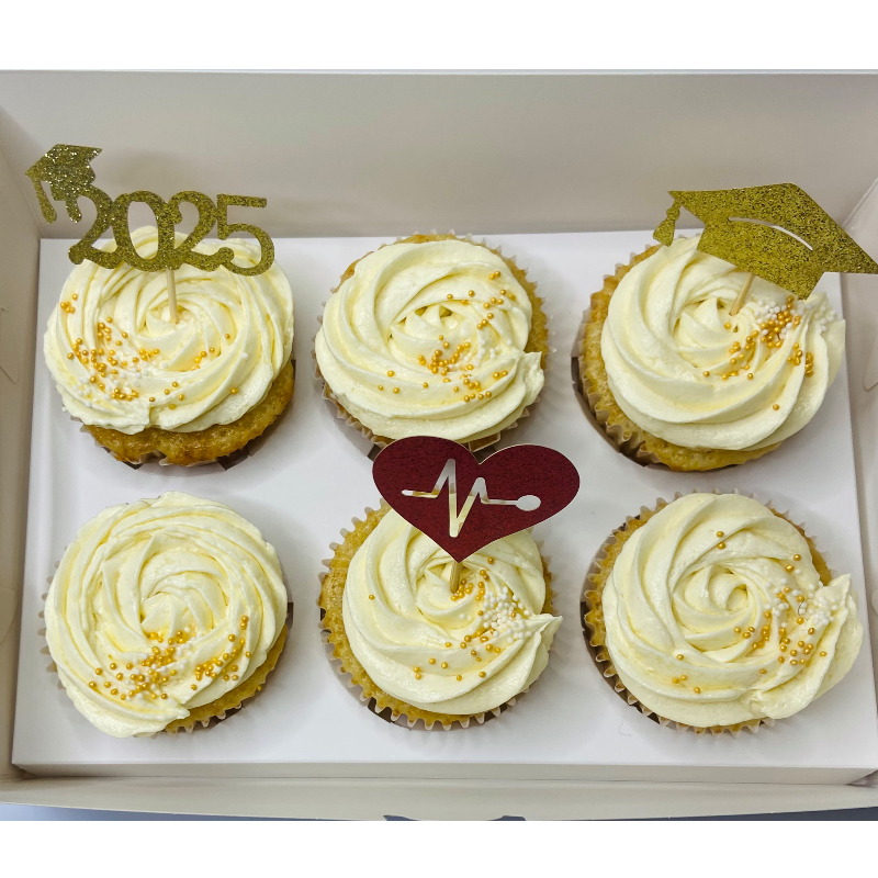 White frosting with gold and red toppers