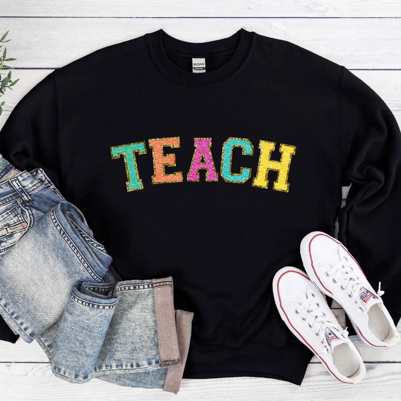 TEACH (chenille letters on black)