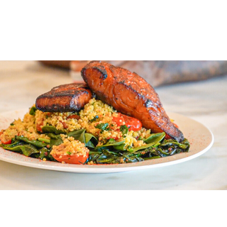 Honey Siracha Salmon over couscous and steamed spinach 