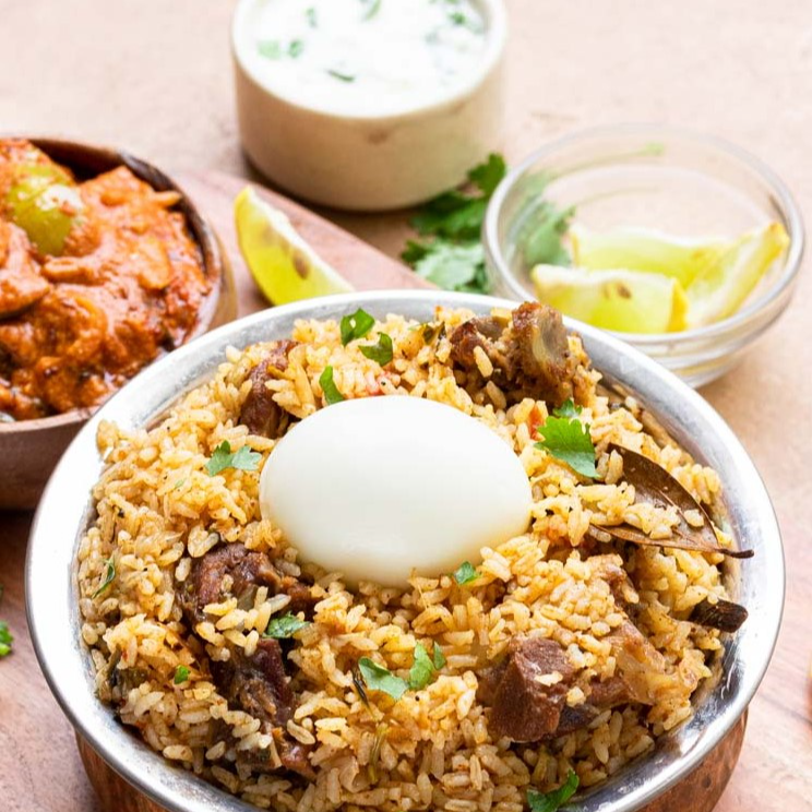 Thalappakatti Mutton Biryani with Eggplant Curry, Raita and Egg