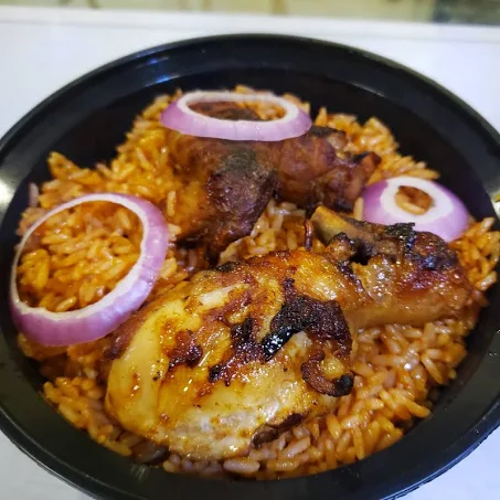 Jollof Rice served with Coleslaw & Grilled Chicken Breast